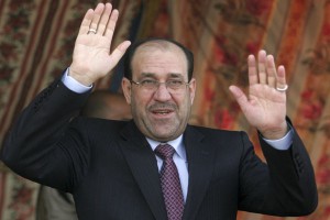 Iraq's Prime Minister Nuri al-Maliki waves to supporters during a political rally in Kerbala